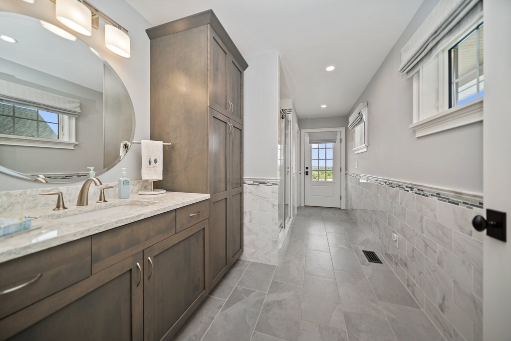 17 Chestnut Lane Littleton, MA 01460 - Photo 15 of 40 a spacious bathroom with a granite countertop sink a mirror and a shower