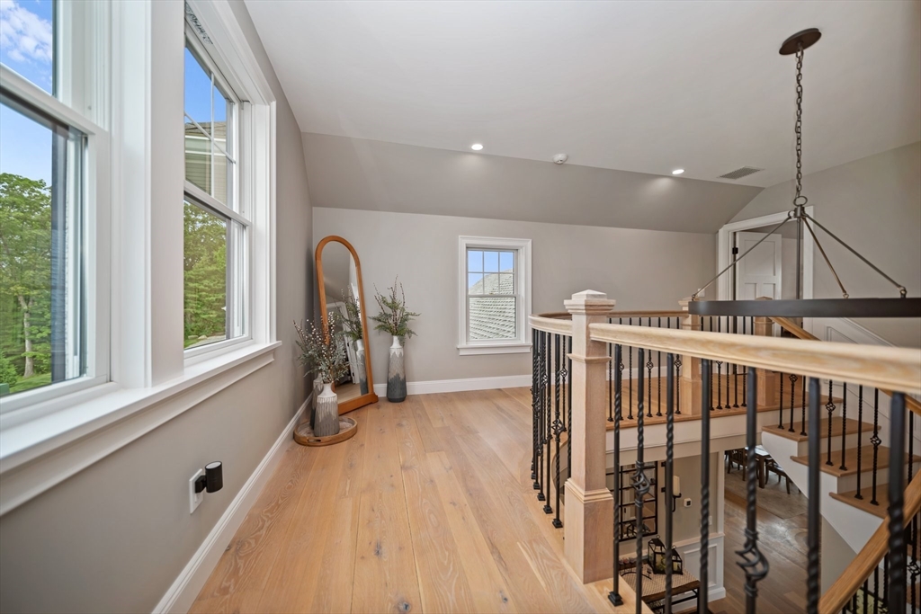 17 Chestnut Lane Littleton, MA 01460 - Photo 18 of 40 a view of a hallway with wooden floor and windows
