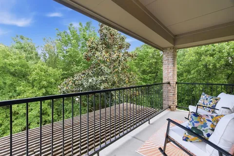 a view of balcony with deck and outdoor seating