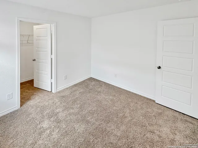 an empty room with closet area