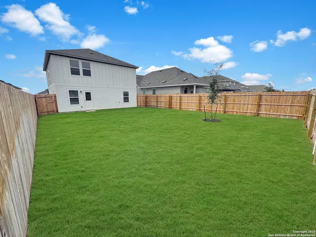 a view of a yard in front of a house with a yard