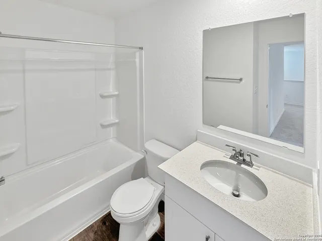a bathroom with a sink toilet and bathtub