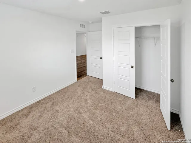 an empty room with closet area