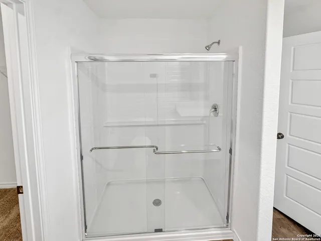 a bathroom with a glass shower door