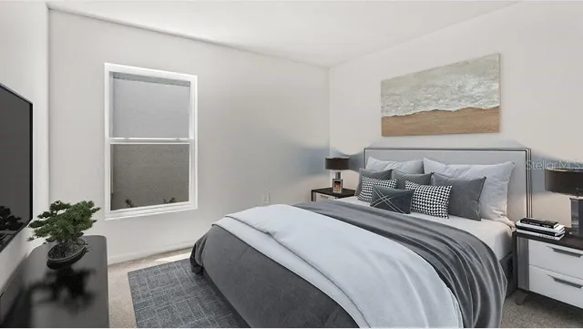 a bedroom with bed and a painting on the wall