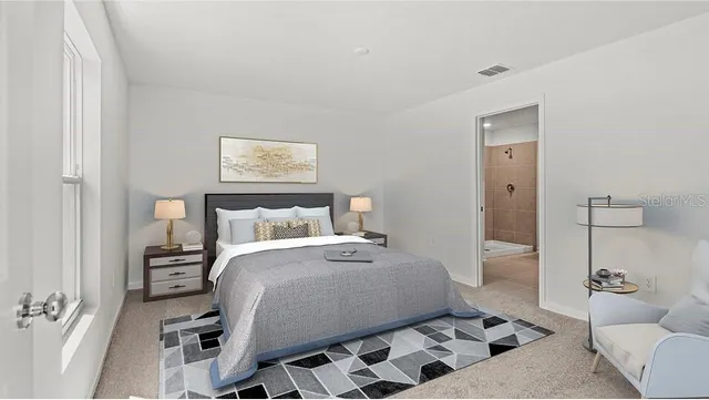 a bedroom with a bed and a view of bathroom