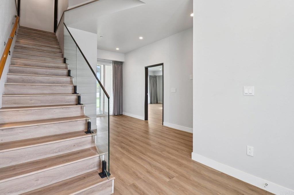 139-41 Almond Street Fallbrook, CA 92028 - Photo 13 of 35 a view of staircase with wooden floor and white walls