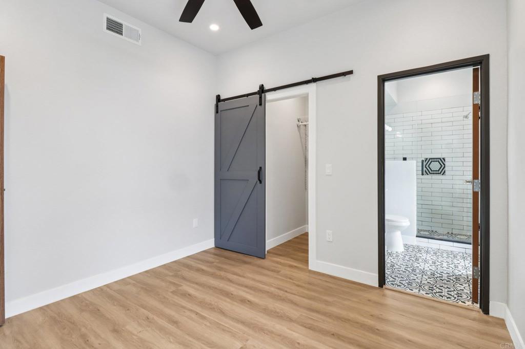 139-41 Almond Street Fallbrook, CA 92028 - Photo 22 of 35 a view of empty room with wooden floor and fan