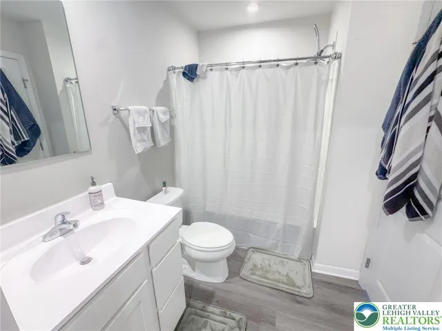 a bathroom with a sink toilet and shower
