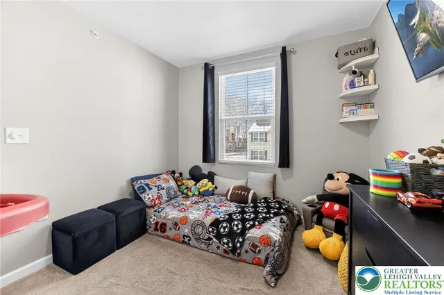 a bedroom with furniture toys and a window