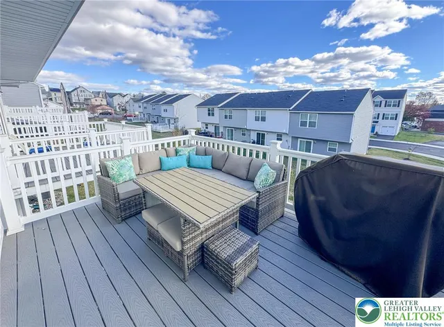 a view of a roof deck with wooden floor and city view