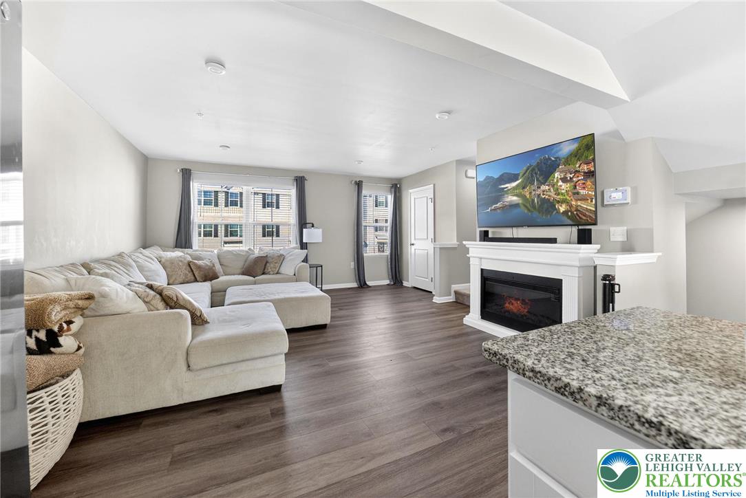 2132 Cross Country Road Northampton, PA 18067 - Photo 5 of 24 a living room with furniture a fireplace and a flat screen tv