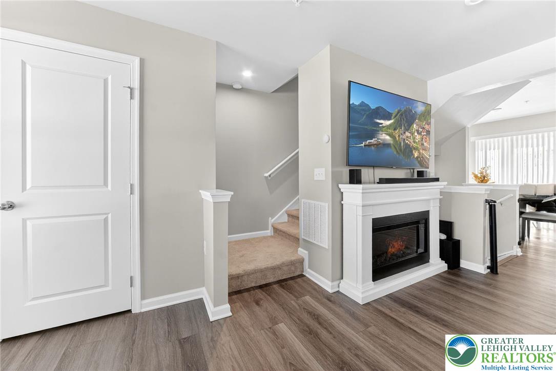 2132 Cross Country Road Northampton, PA 18067 - Photo 6 of 24 a view of an empty room with wooden floor and fireplace