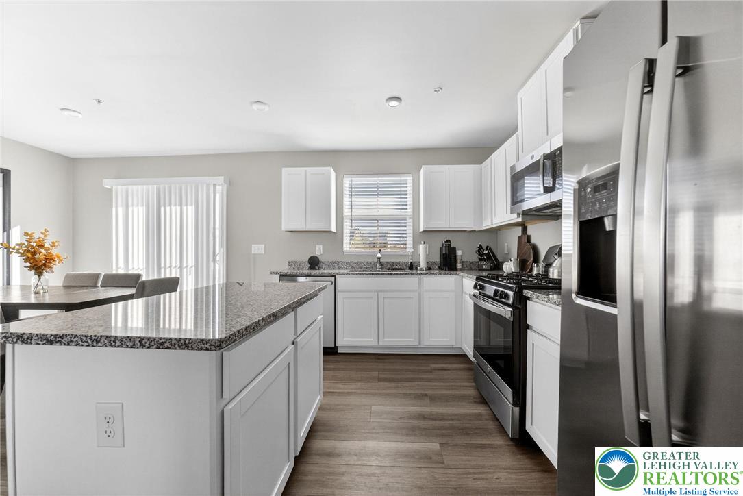 2132 Cross Country Road Northampton, PA 18067 - Photo 7 of 24 a kitchen with kitchen island granite countertop a sink stove and refrigerator