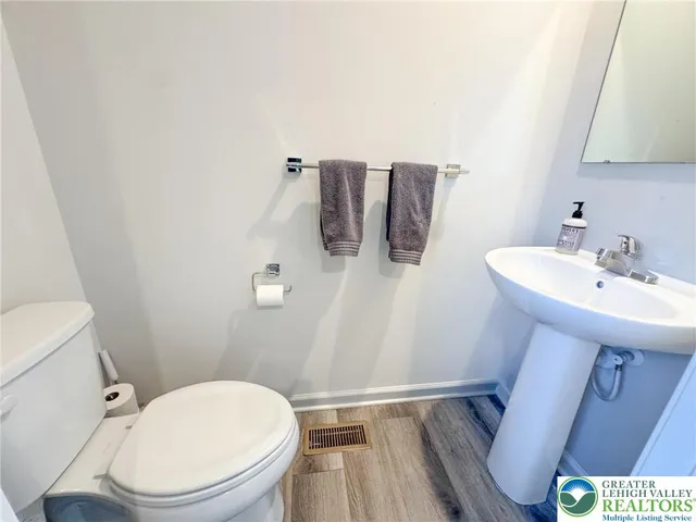 a white toilet sitting next to a bathroom sink