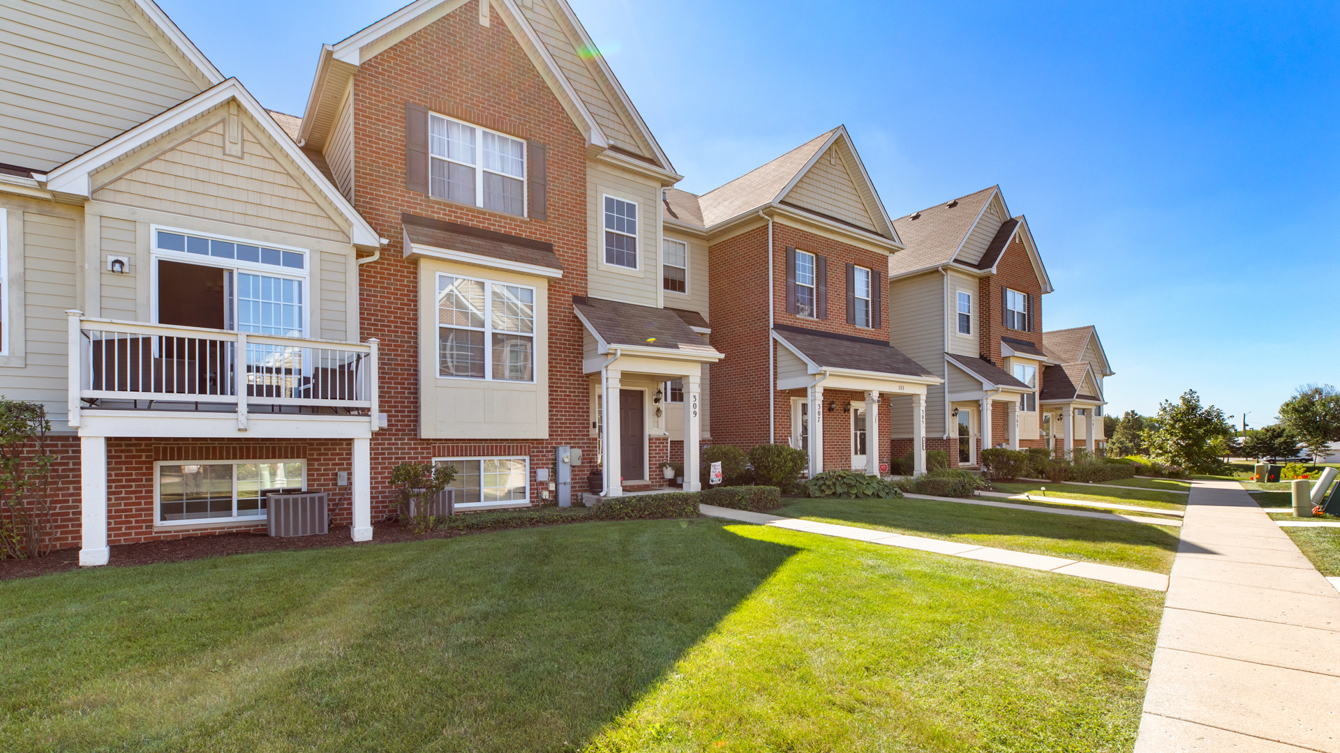 309 Timber Ridge Court Joliet, IL 60431 - Photo 2 of 18 a front view of a residential apartment building with a yard
