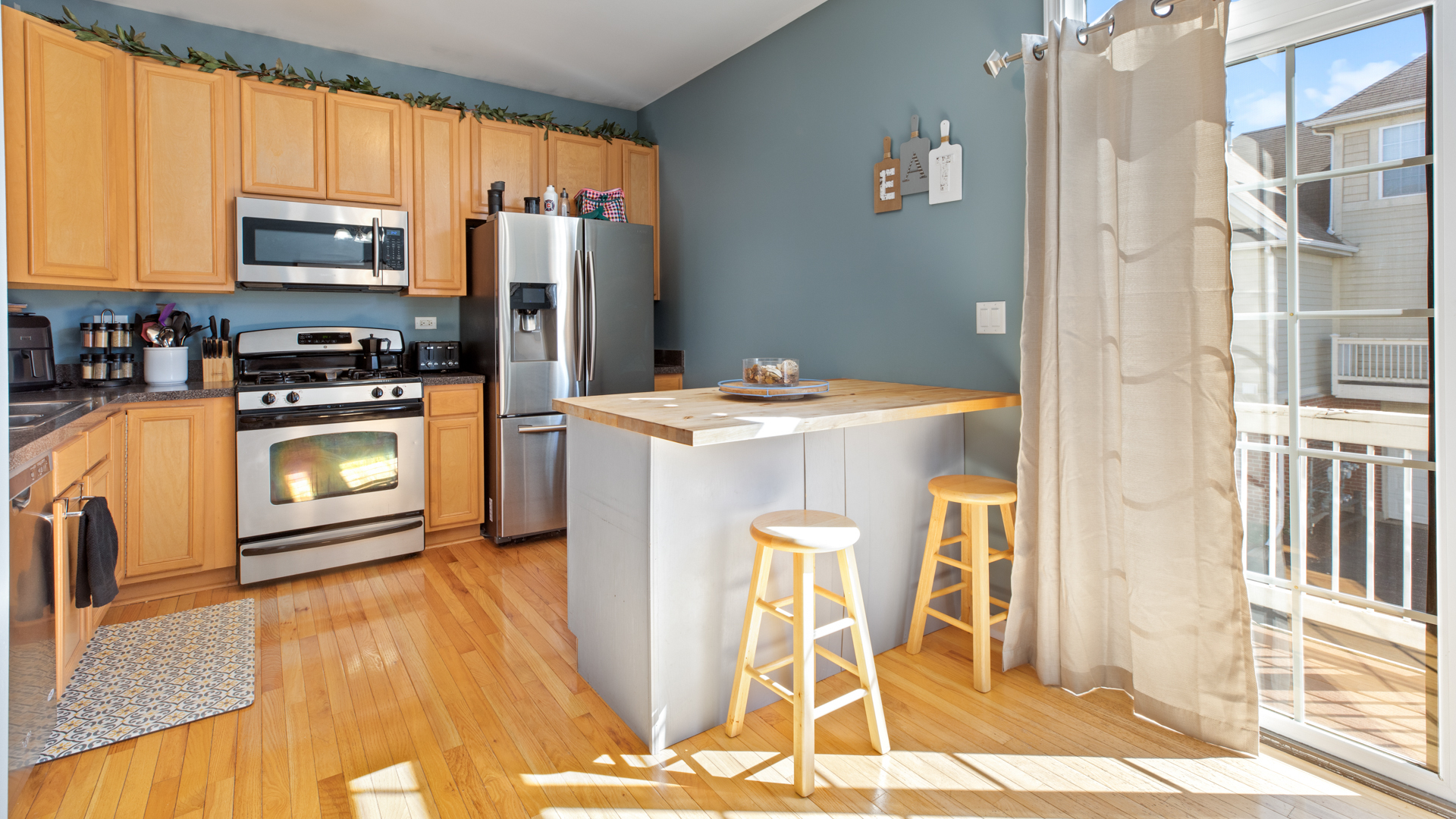 309 Timber Ridge Court Joliet, IL 60431 - Photo 8 of 18 a kitchen with stainless steel appliances granite countertop a refrigerator a stove a sink and white cabinets with wooden floor