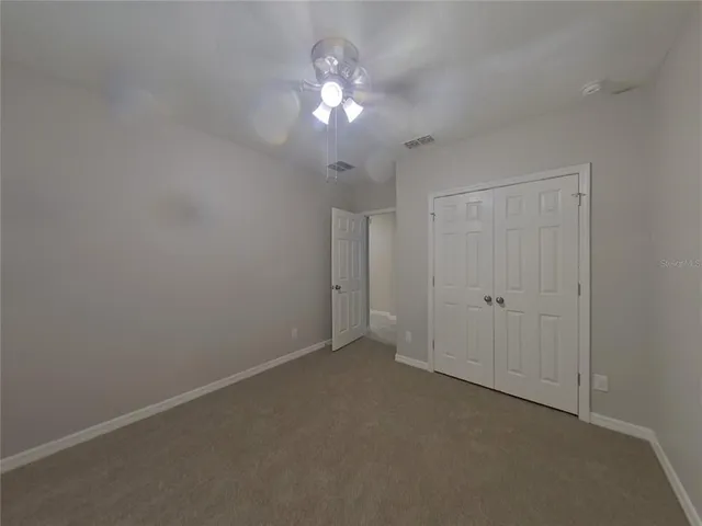 a view of a chandelier fan and entryway