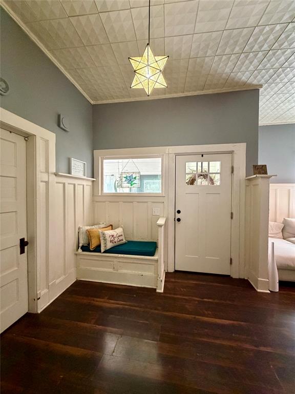 301 Forrest Avenue Cleburne, TX 76033 - Photo 6 of 14 Entryway featuring dark wood-finish flooring, white paneled wainscoting, and a built-in bench