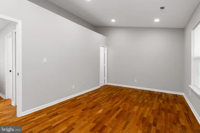 an empty room with wooden floor