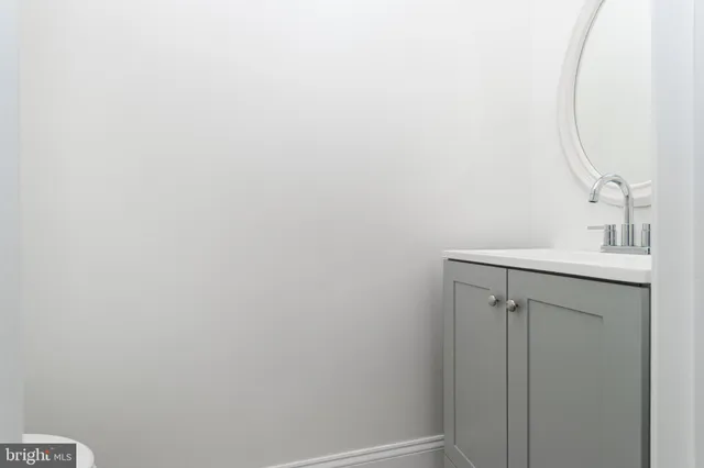 a bathroom with a sink and vanity