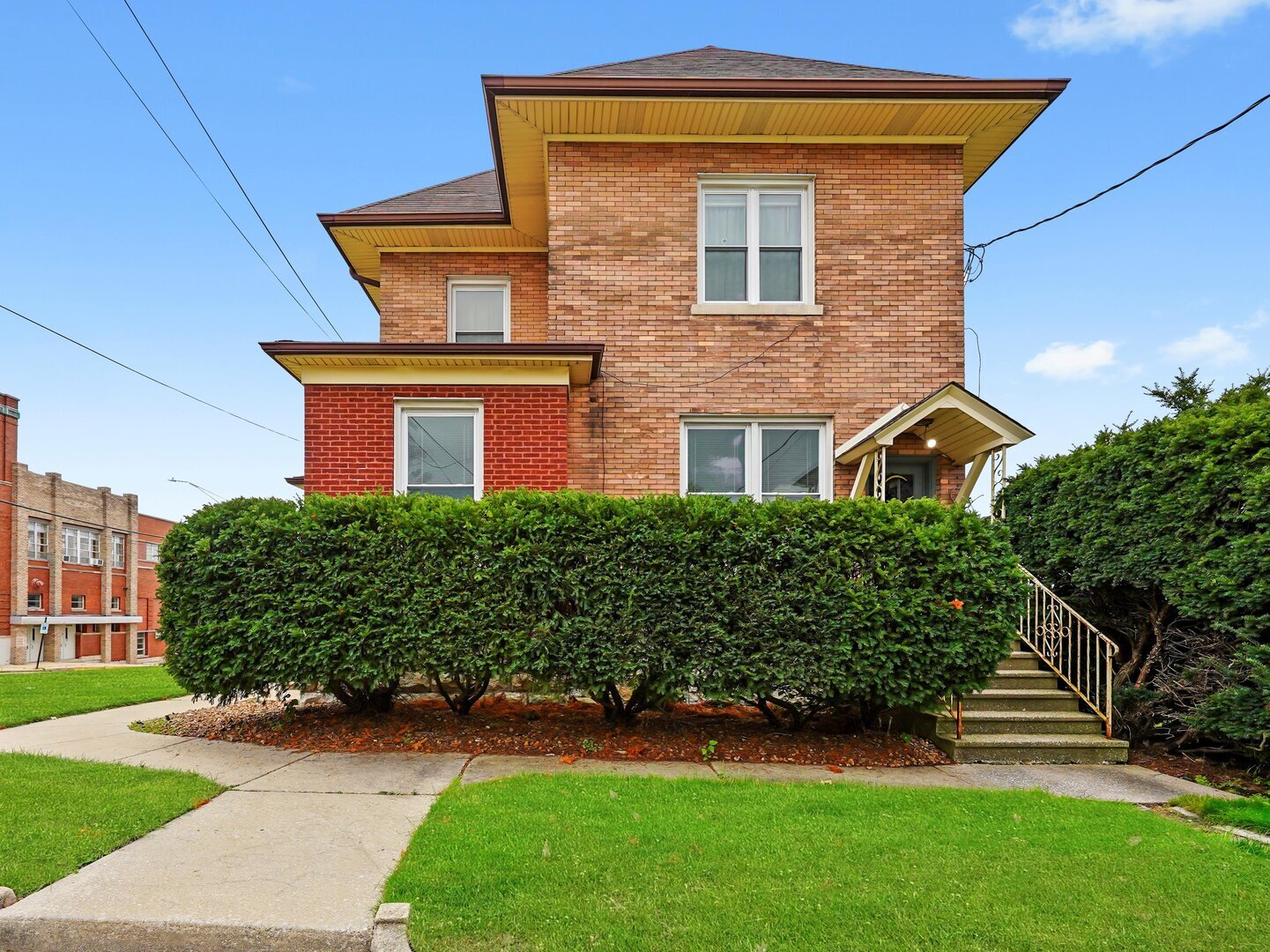 a front view of a house with a garden