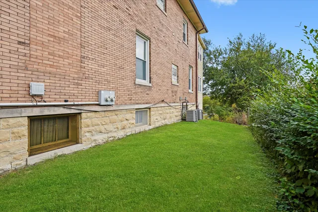 a view of a brick house with a yard