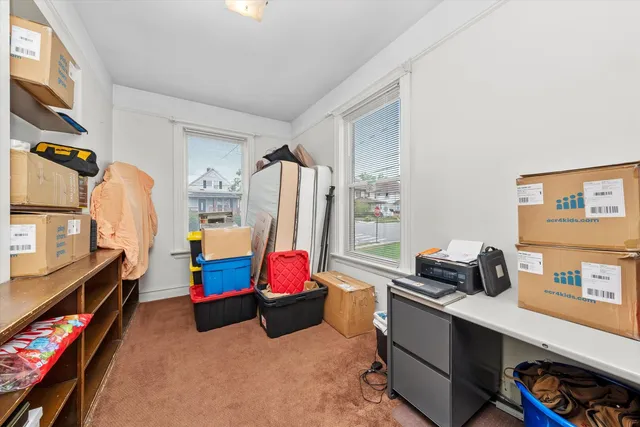 a living room with furniture a flat screen tv and a window