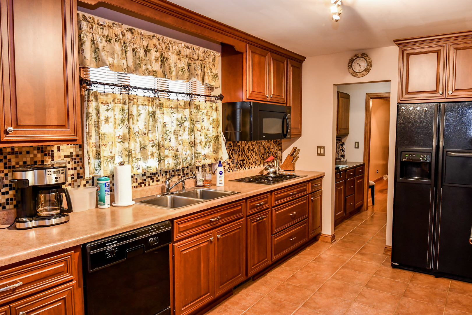 731 Spring Road Elmhurst, IL 60126 - Photo 7 of 23 a kitchen with stainless steel appliances granite countertop a refrigerator a sink dishwasher stove and oven with wooden cabinets