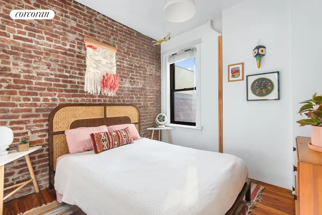a living room with patio furniture and a flat screen tv