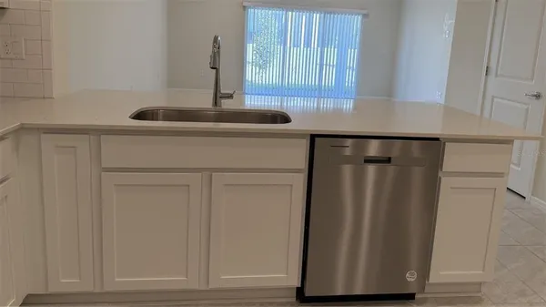 a kitchen with refrigerator and window