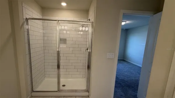 a bathroom with a glass shower door