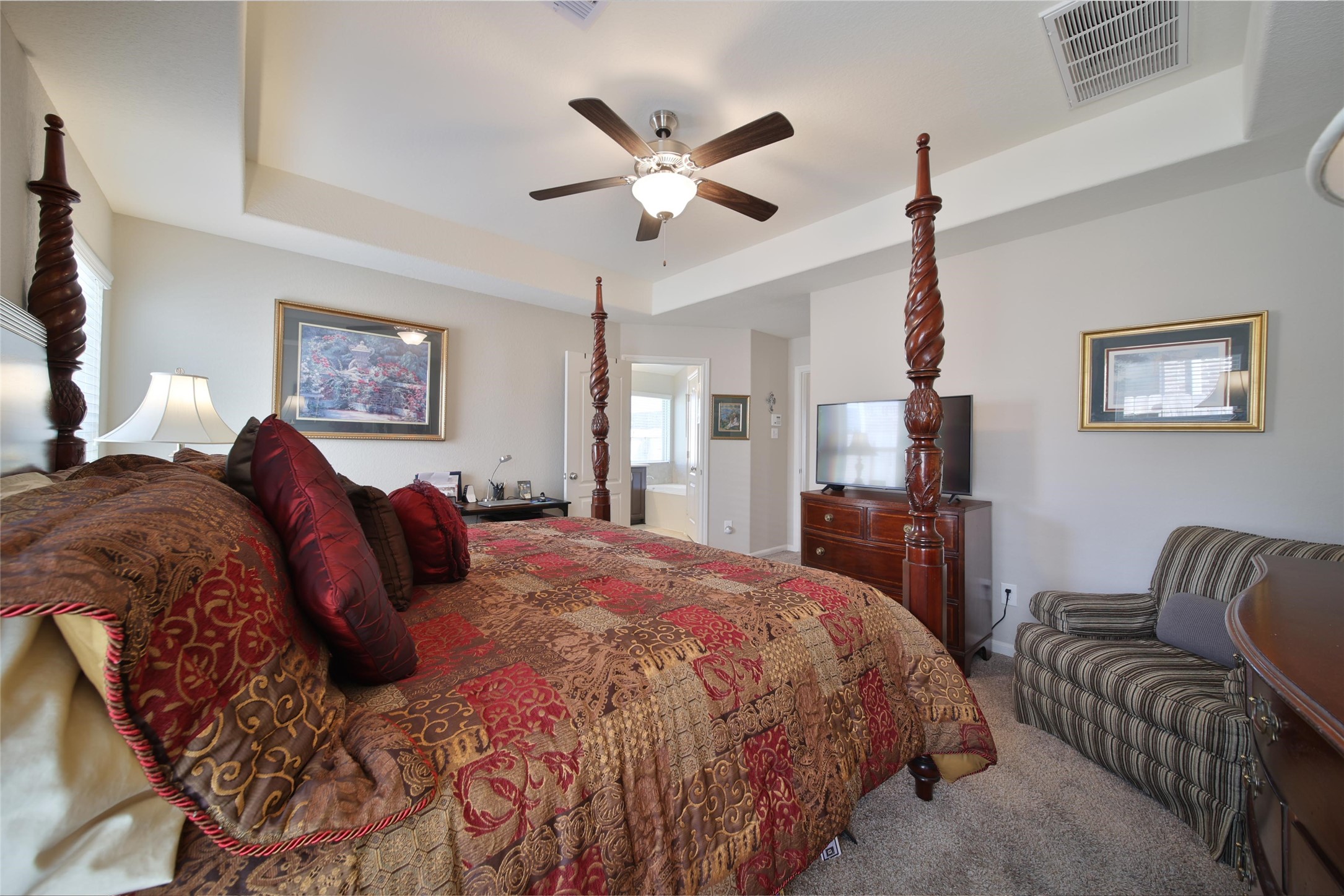 214 Pleasant Hill Way Conroe, TX 77304 - Photo 21 of 43 The large bedroom features a tray ceiling and space for your larger furniture pieces.