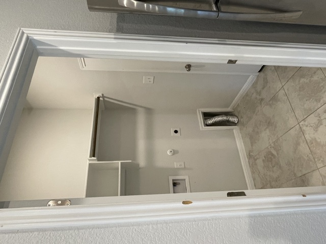 12401 Amber Lynn Path Manor, TX 78653 - Photo 6 of 33 A dedicated laundry space provides practical storage solutions and durable tile flooring.