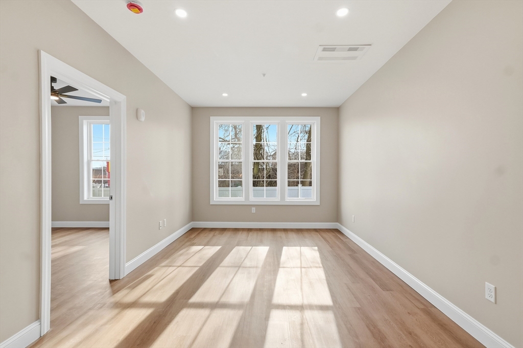 8 Vine Street, Unit 2 Haverhill, MA 01830 - Photo 7 of 20 a view of an empty room with glass door and windows