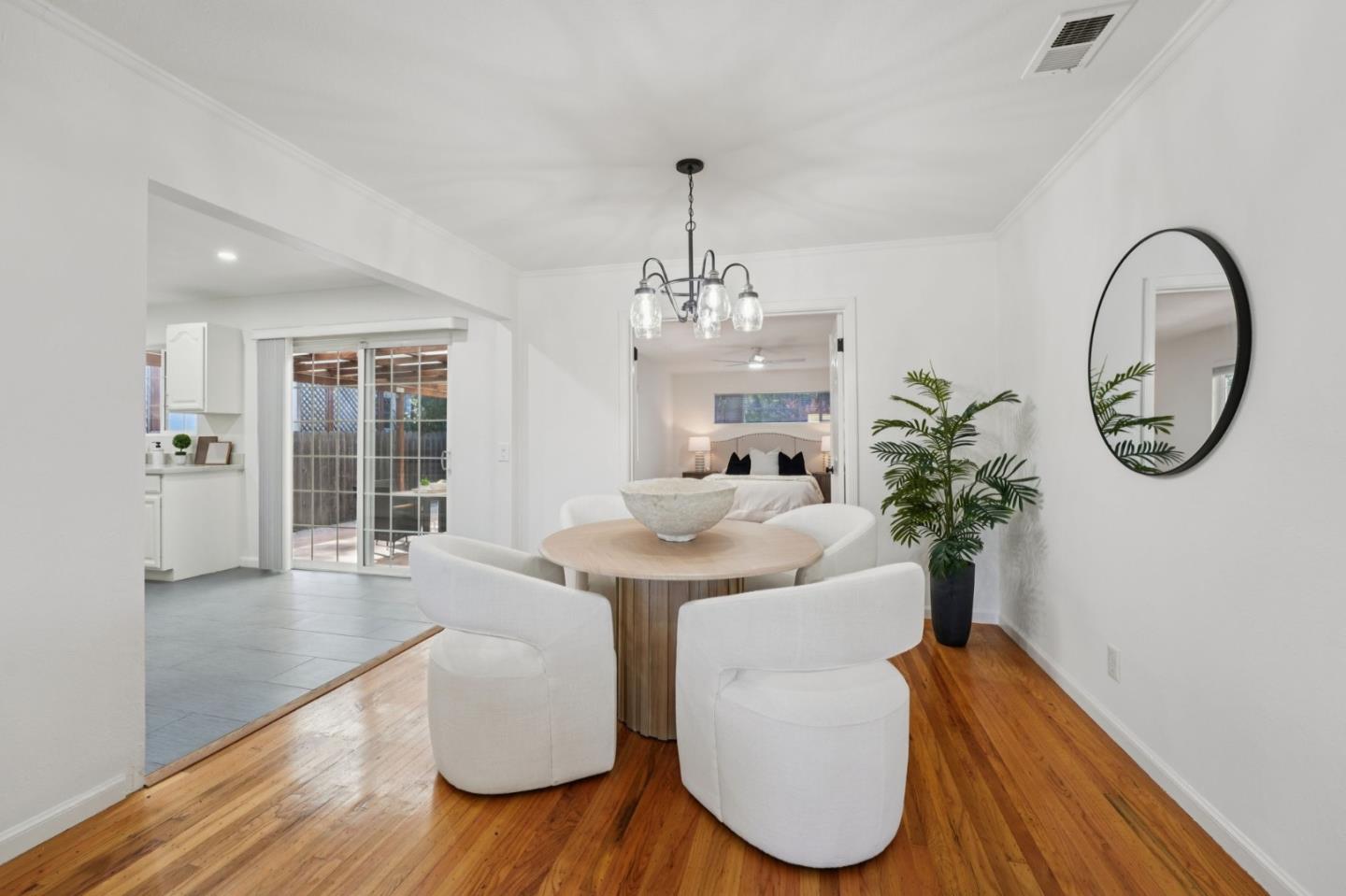3336 Spring Street Redwood City, CA 94063 - Photo 11 of 40 a dining room with furniture a potted plant and wooden floor