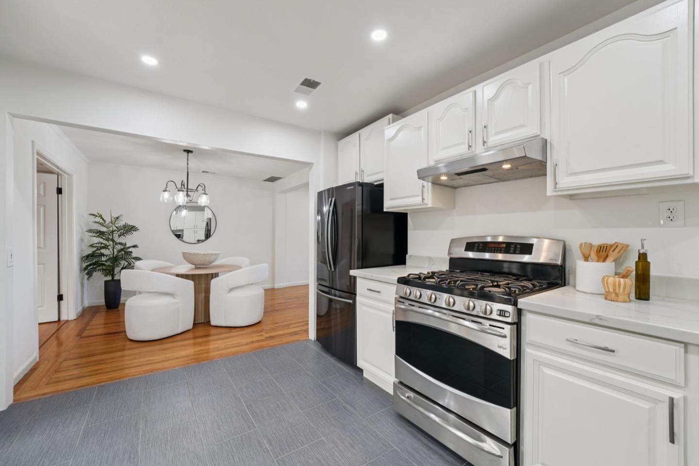 3336 Spring Street Redwood City, CA 94063 - Photo 19 of 40 a kitchen with a stove and a white wooden cabinets