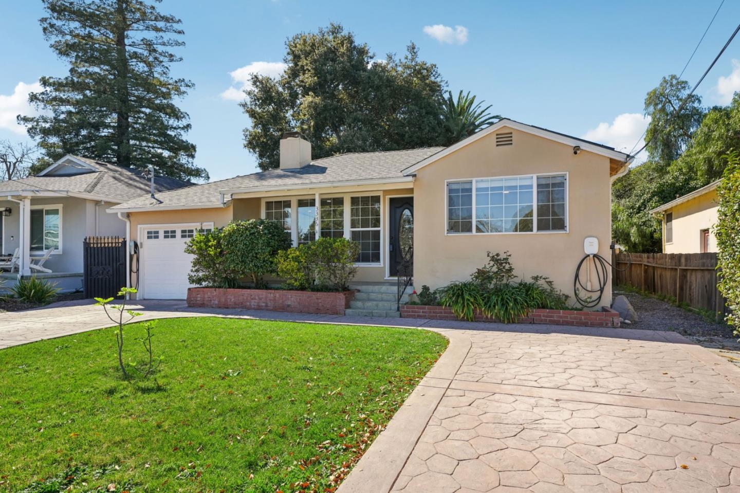 3336 Spring Street Redwood City, CA 94063 - Photo 2 of 40 a front view of a house with a yard and potted plants