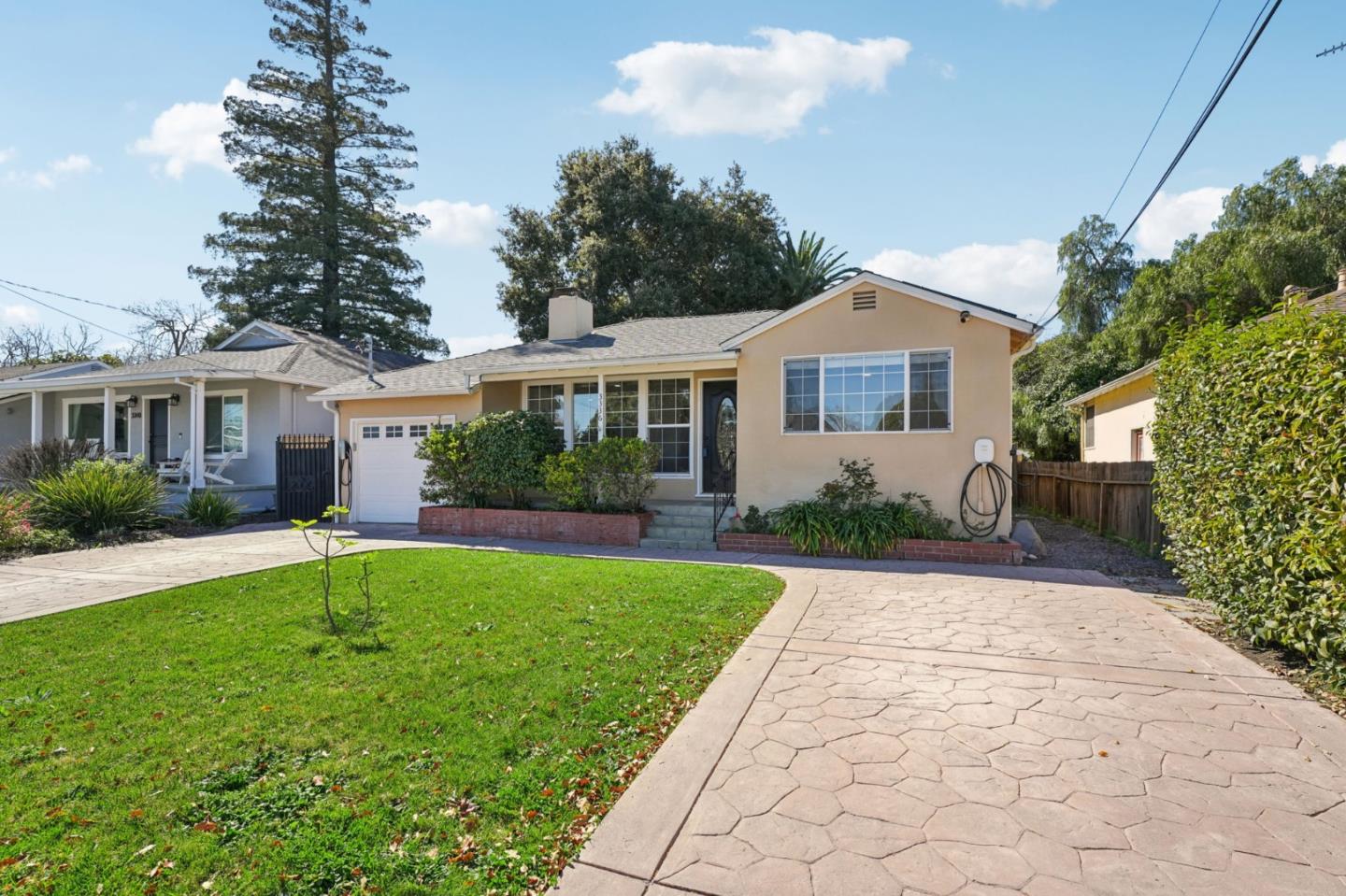 3336 Spring Street Redwood City, CA 94063 - Photo 3 of 40 a front view of a house with a yard and potted plants