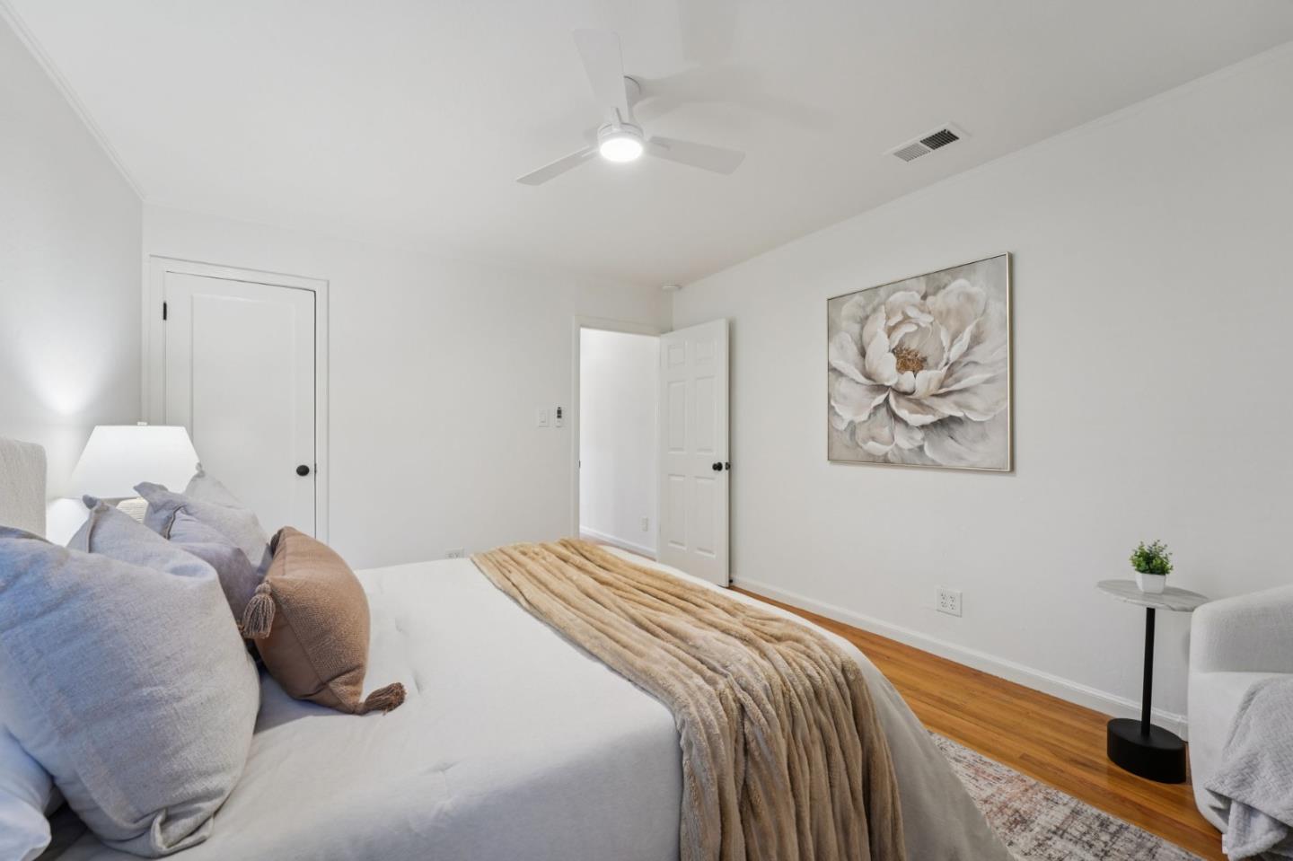 3336 Spring Street Redwood City, CA 94063 - Photo 33 of 40 a bedroom with a bed and a chandelier