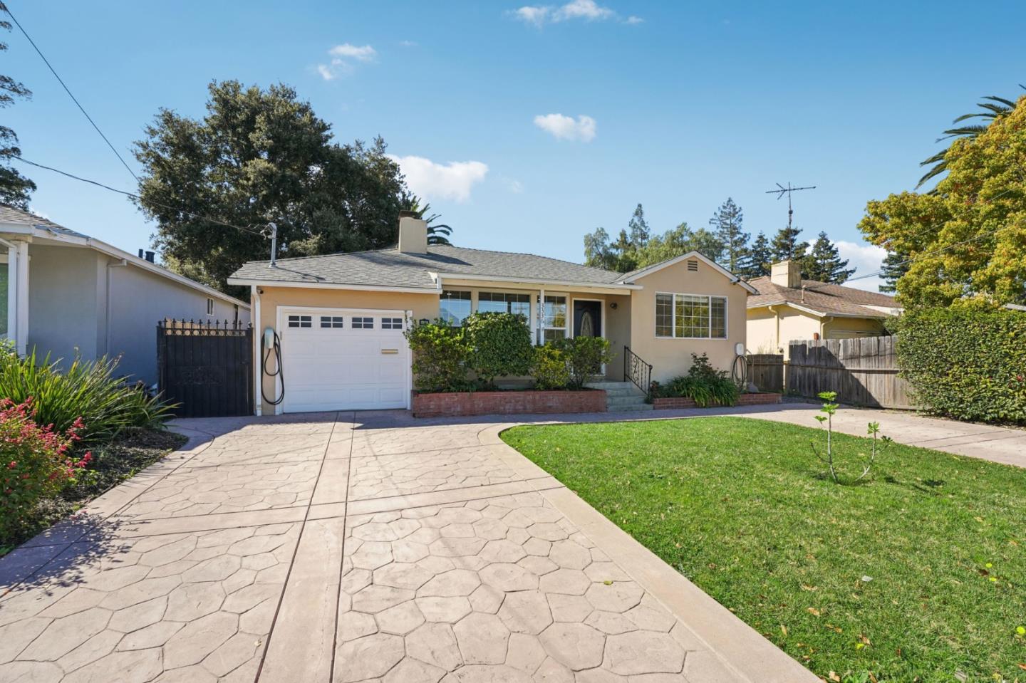 3336 Spring Street Redwood City, CA 94063 - Photo 4 of 40 a front view of a house with a yard and trees