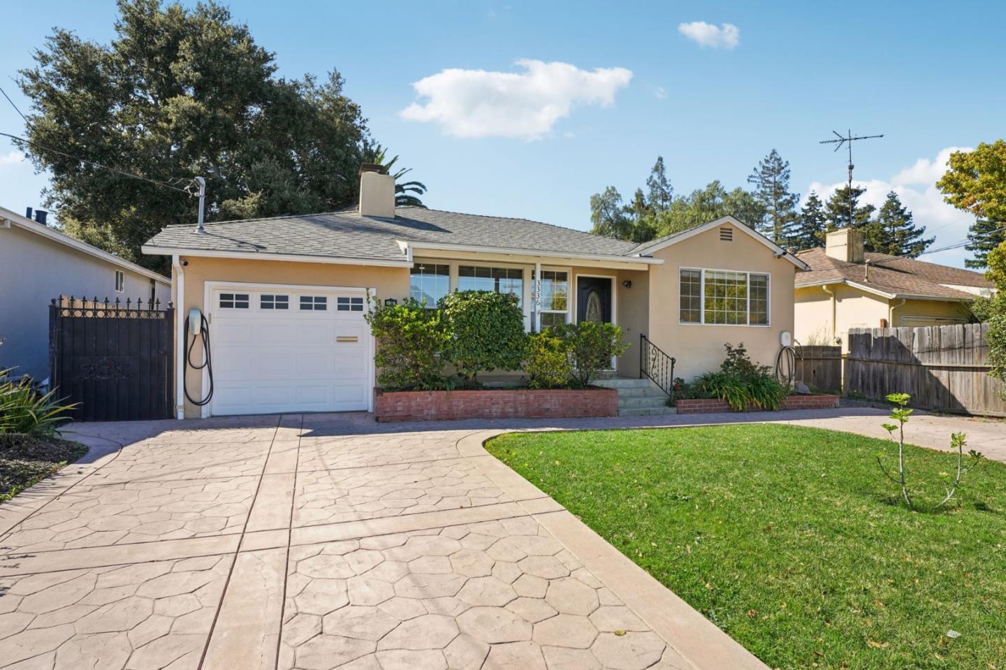3336 Spring Street Redwood City, CA 94063 - Photo 5 of 40 a front view of a house with a yard and potted plants