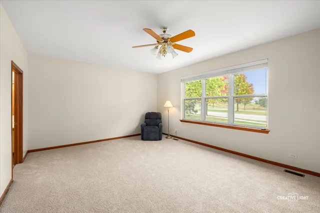 a view of a livingroom with a ceiling fan and entryway