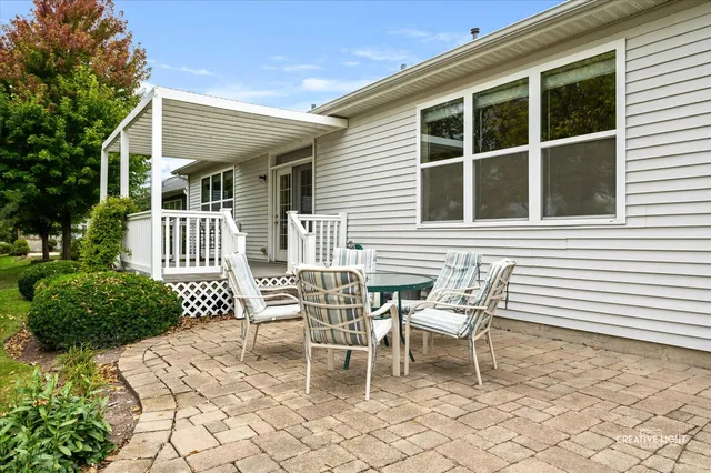 a view of a house with backyard sitting area and garden