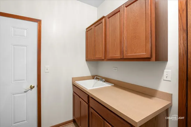 a kitchen with a stove a sink a dining table and chairs