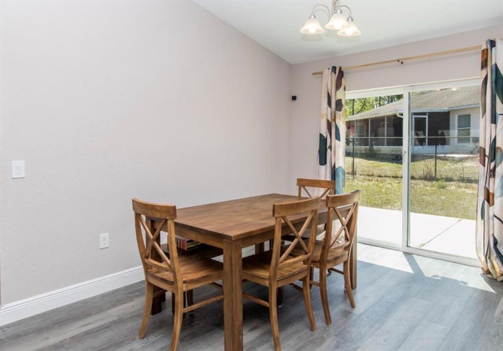 14 Hemlock Loop Court Ocala, FL 34472 - Photo 12 of 27 a view of a dining room with furniture and wooden floor