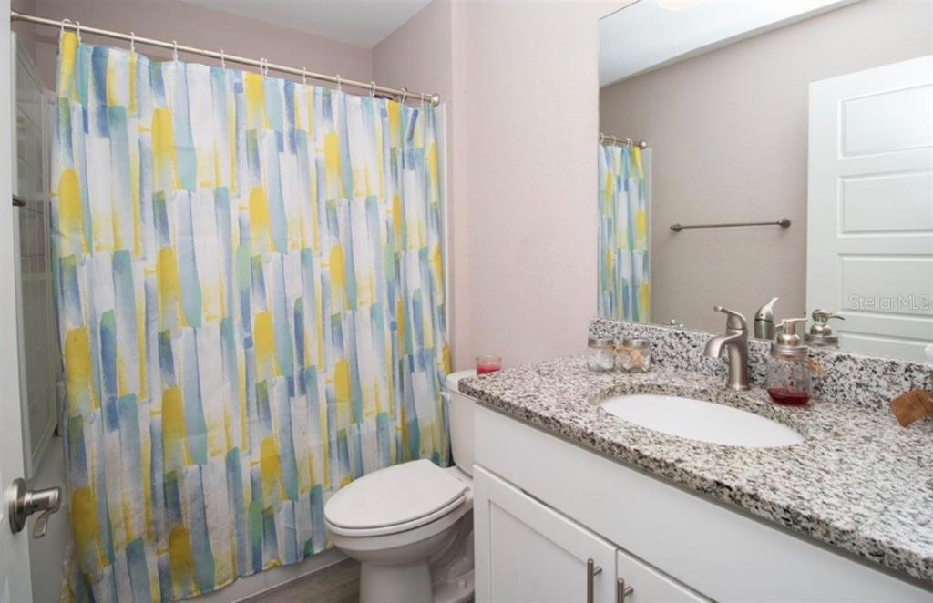 14 Hemlock Loop Court Ocala, FL 34472 - Photo 14 of 27 a bathroom with a granite countertop sink and a mirror