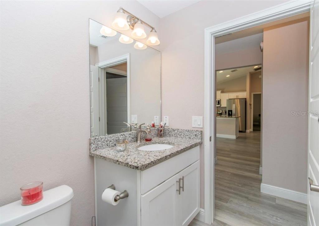 14 Hemlock Loop Court Ocala, FL 34472 - Photo 15 of 27 a bathroom with a granite countertop sink and a mirror