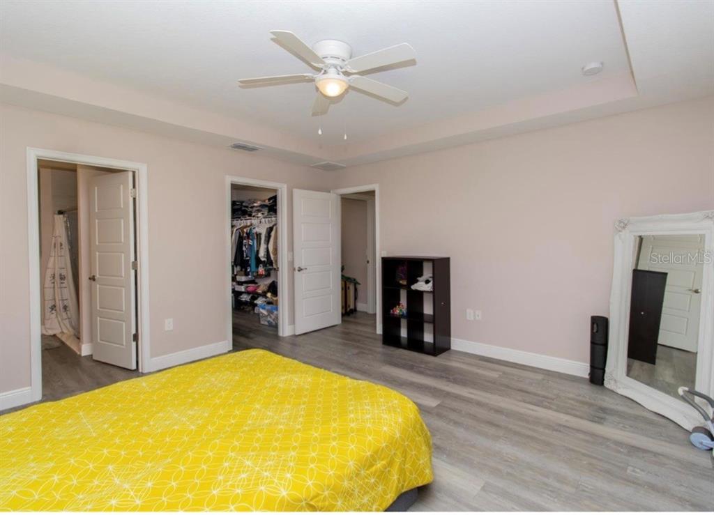 14 Hemlock Loop Court Ocala, FL 34472 - Photo 22 of 27 a bed room with a bed and a chandelier