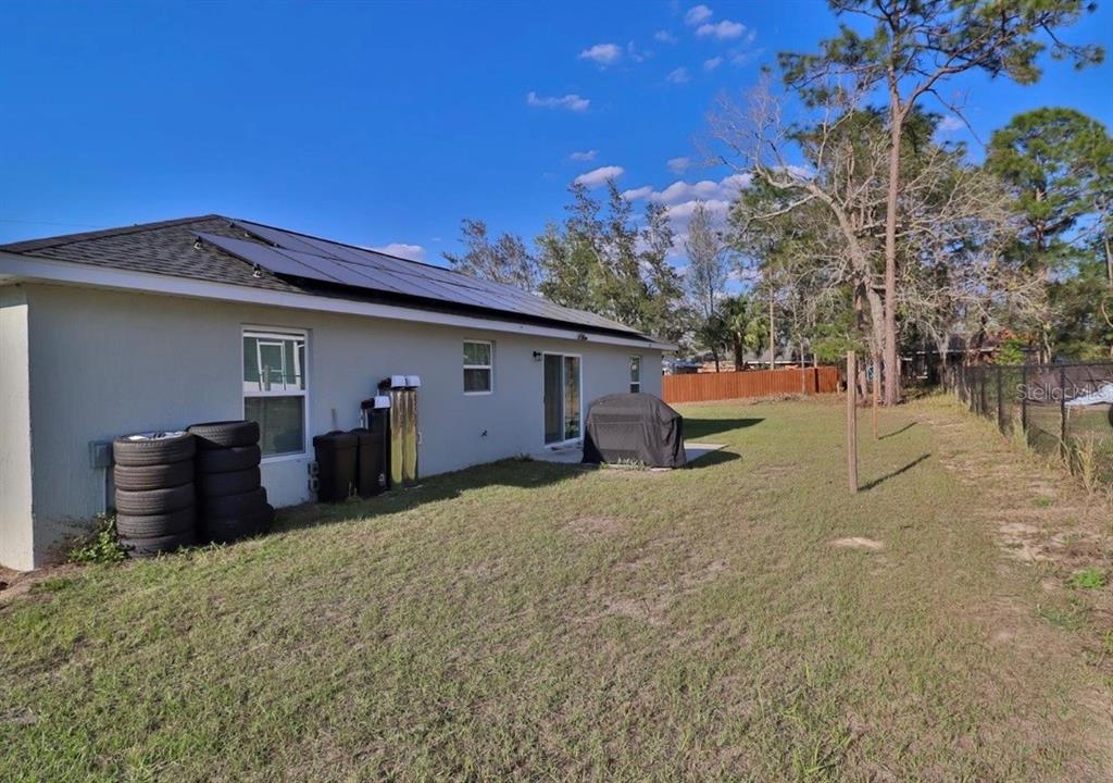 14 Hemlock Loop Court Ocala, FL 34472 - Photo 26 of 27 a view of a house with backyard and a tree